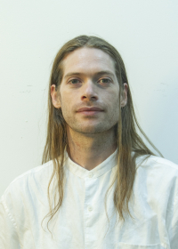 Head and Shoulders of Thane Lund wearing white shirt, with long, straight, dirty-blonde hair